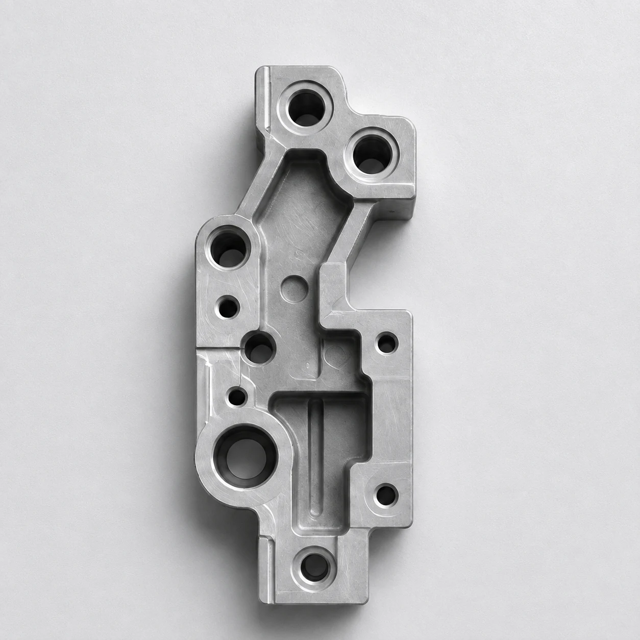 A top-down capture of a tall precision-machined aluminium bracket.
